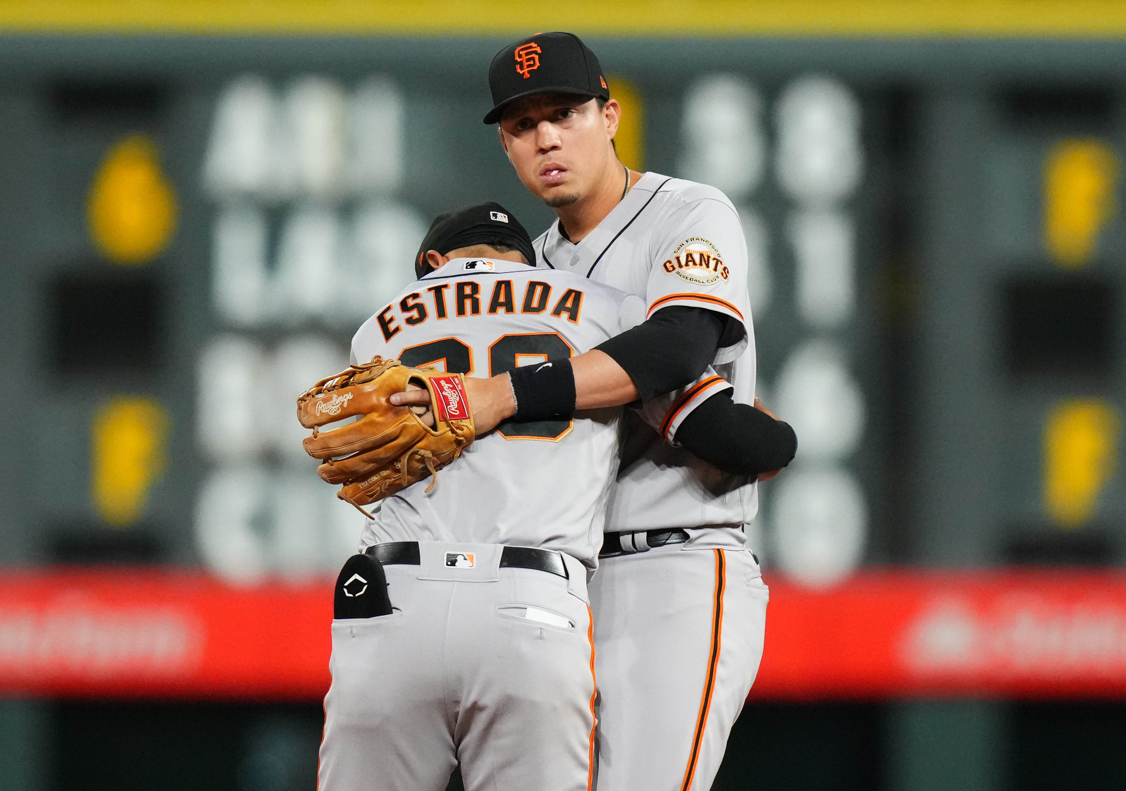 SF Giants infielders Wilmer Flores and Thairo Estrada embrace. (2022)